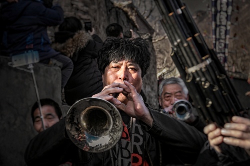 Suona player in mountain village