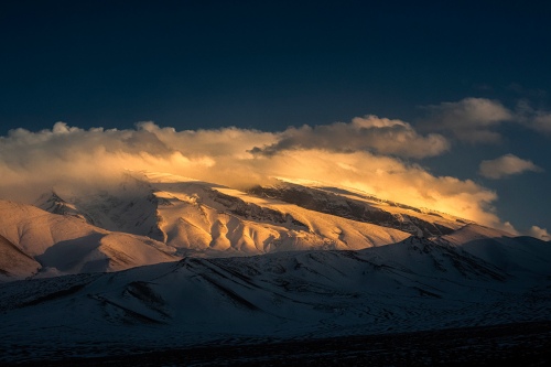 Sun shines on the snow mountain